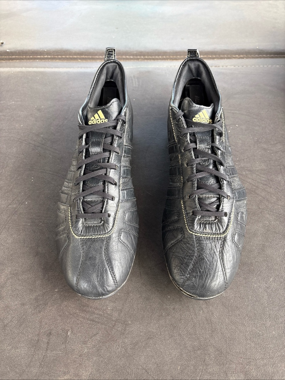 adidas Men’s Black Leather Athletic Shoes with Gold Logos